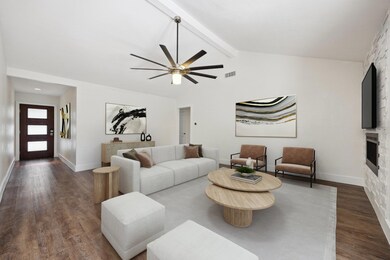 Living area featuring dark wood-type flooring, a 