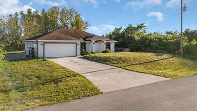 View of front of home with driveway, stucco siding, and an attached garage