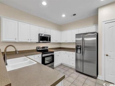 Kitchen featuring light tile patterned floors, whi