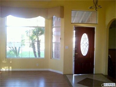 Entry to living room with decorative tile and vaul