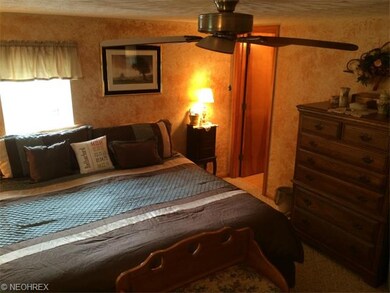 Master bedroom with attached half bath.