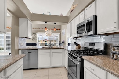 Kitchen featuring light tile patterned floors, lig