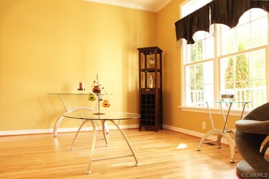 Formal Living room with crown molding and hardwood