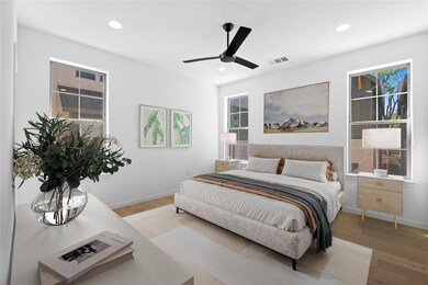 Bedroom with light wood-style floors, baseboards,