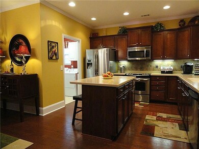 Kitchen with island, cherry cabinets with pull out shelves.