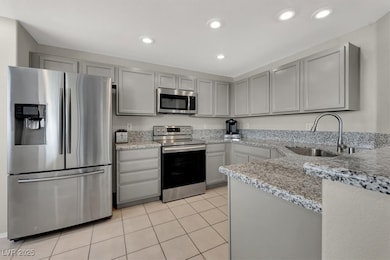 Kitchen with stainless steel appliances, a sink, l