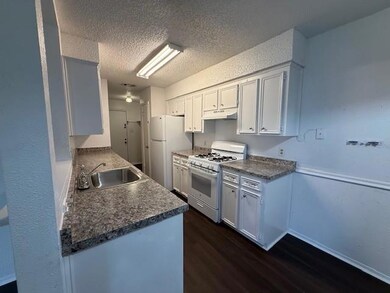 Kitchen with white appliances, under cabinet rang