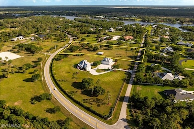 Birds eye view of property with a water view and a