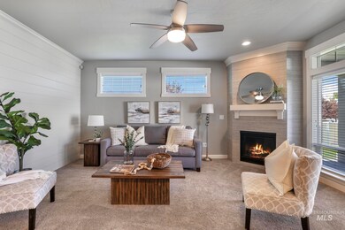 Living room with carpet flooring, ceiling fan, a fireplace, and recessed lighting