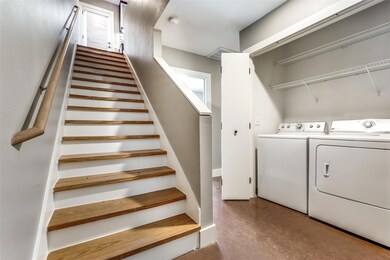 First floor with wood stairs, full-sized laundry r