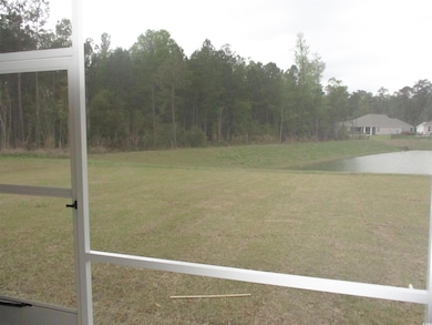 View of grassy yard with a water view
