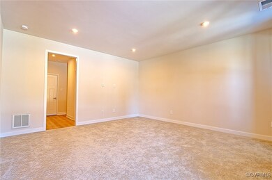 Spare room with light colored carpet, visible vents, baseboards, and recessed lighting