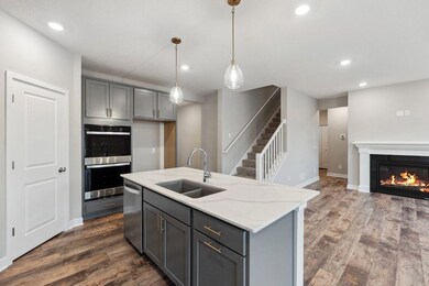 Upgraded Kohler undermount sink and pull out faucet make clean up a breeze! Living room fireplace has a stone surround and painted mantle.