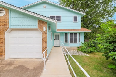 View of front facade with concrete driveway, a ga