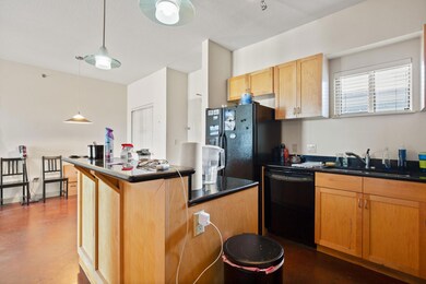 Kitchen with black appliances, dark countertops, 
