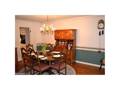 Dining room with hardwood flooring, crown molding 