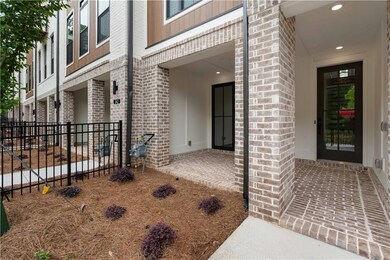 Front entry on the terrace level with a covered brick patio welcomes you and your guests.
