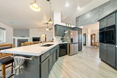 Kitchen featuring black appliances, a sink, a peni