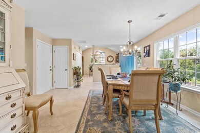 Tiled dining room featuring an inviting chandelier