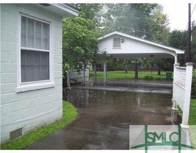 Exterior Front. Large Carport area next to side en