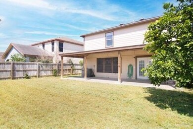 Back of property featuring a lawn and a patio area