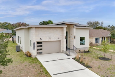 Modern home featuring stone siding, stucco siding