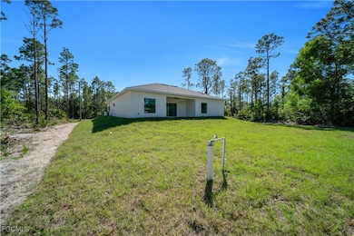 View of front of house featuring stucco siding, a