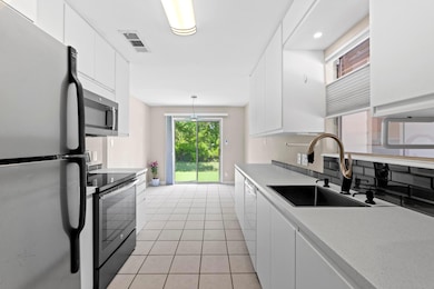 Kitchen with stainless steel appliances, a sink, 