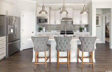 Kitchen with an island with sink, pendant lighting