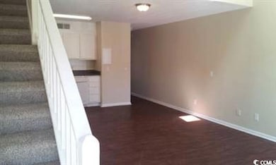 Stairway featuring baseboards and wood finished floors