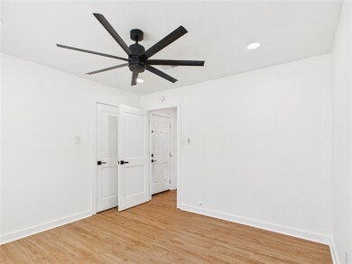 Spare room featuring baseboards, light wood finish