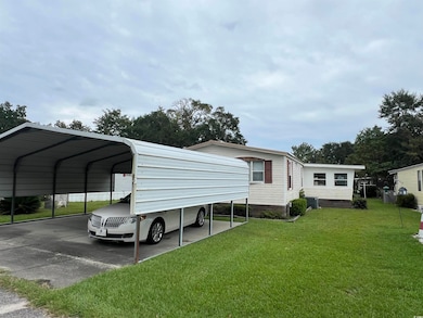View of parking with a carport and driveway
