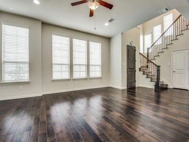 Unfurnished living room featuring ceiling fan and 