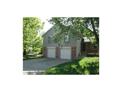Wood siding and brick trim.  Each duplex has 1-car