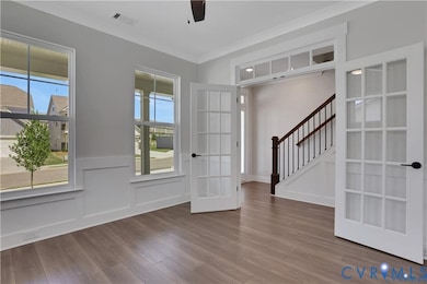 Photo represents the plan, not the actual home. Design selections may vary. A home office with French doors directly off of the entryway.
