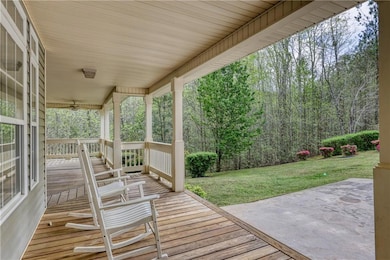 Deck with a wooded view and a yard