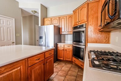 Kitchen with light countertops, light tile pattern
