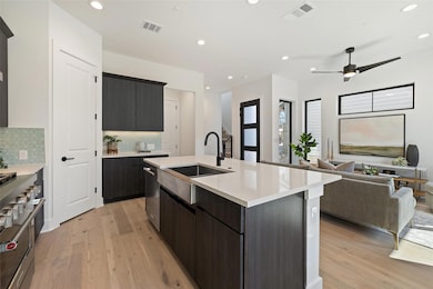 Kitchen with light wood-style flooring, a sink, s