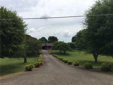 Long driveway leads to main home with lots of road frontage and a large front yard. Second home (cottage) has its own driveway.