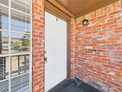 Entrance to property with brick siding