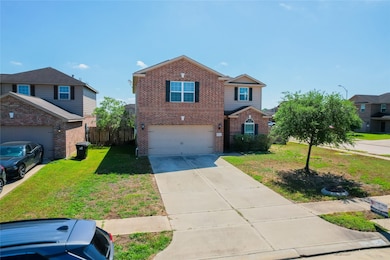 This photo shows a two-story brick house with a tw
