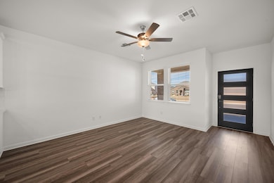 Foyer with ceiling fan and dark hardwood / wood-style flooring