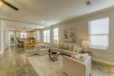 Living room with concrete flooring, recessed light