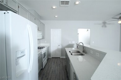 Kitchen featuring white appliances, visible vents,