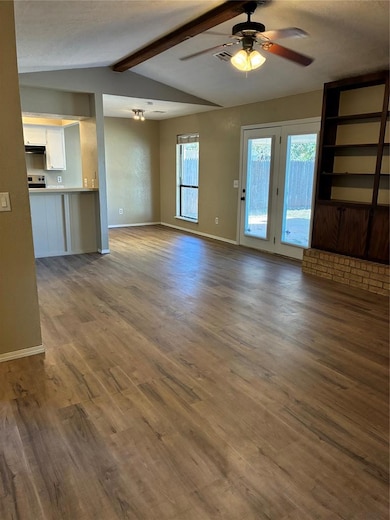 Living room with new wood finished vinyl plank floors, Vaulted Ceiling and ceiling fan