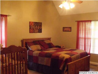 Large master bedroom with vaulted ceiling.