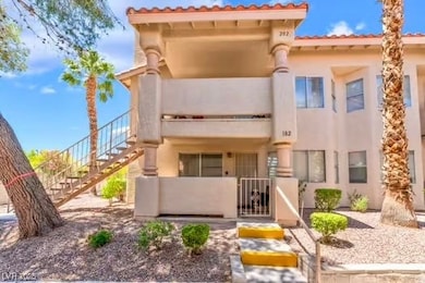 View of front of home featuring stairway, stucco s