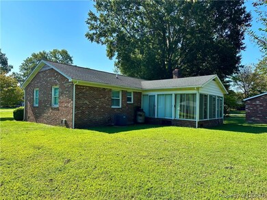 Exterior space with central AC and a front yard