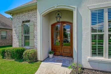 A gas lantern and beautiful double doors accent th