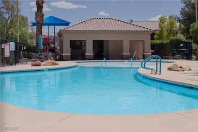 Community pool with fence and a patio area